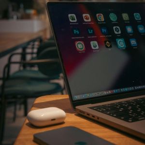 A laptop on a table at an empty cafe.
