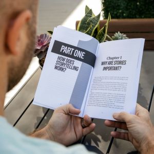 A man is reading a book about how storytelling works.