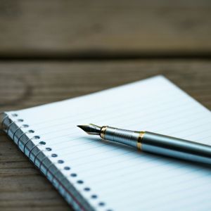 A notebook with an extremely old ink pen.
