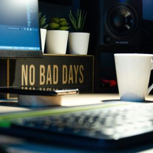 a workstation with a sign that says- no bad days and 3 coffee cups