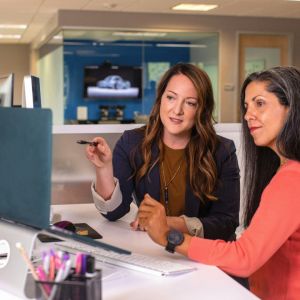 Two women at work reviewing an assignment.