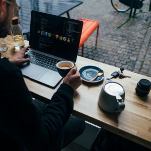 A man in a public space with several drinks.