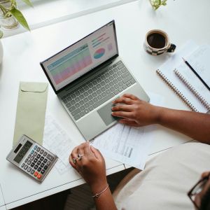 A woman on a computer doing finances.