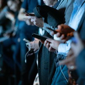 Several men busy on their phones.
