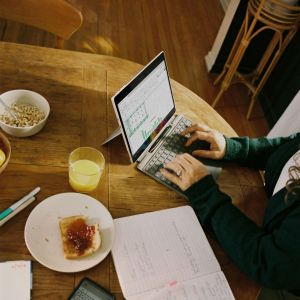 Someone at a table, on a computer.