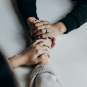 Two women holding hands.
