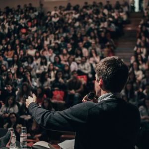 A man speaking to a large crowd.