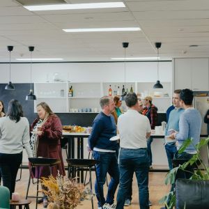 Several small groups of people networking.